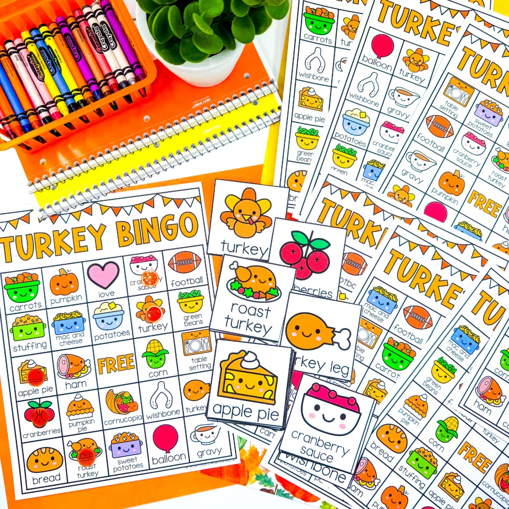 Colorful bingo cards with cartoon food icons (turkey, pie, cranberries) and school supplies like notebooks and pencils.